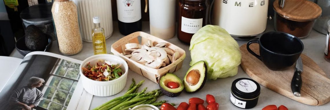 A variety of fresh ingredients and kitchen tools for preparing a healthy meal.